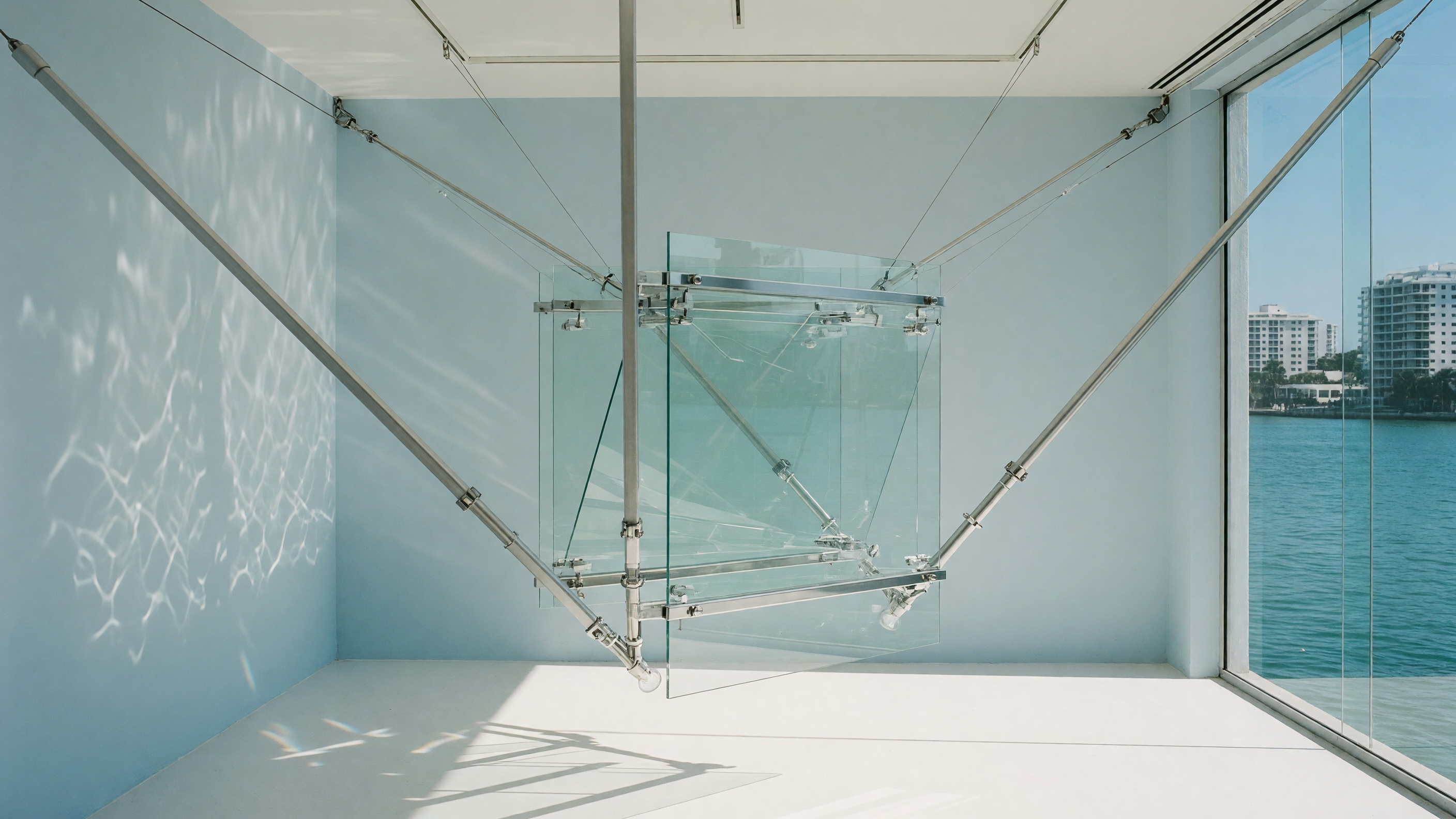 A physical glass-and-aluminum system installation connected by precise structural lines.